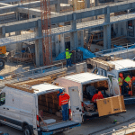 van fleet vehicles on building site unloading with workers being cover by van fleet insurance cover