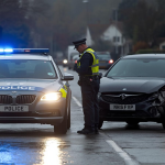 car accident with the police helping the driver to get the details from the other driver and arrange recovery